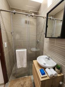 a bathroom with a sink and a shower at Pilarica Gardens in Medellín +172 photos