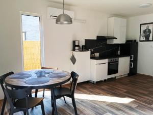 a kitchen and dining room with a table and chairs at DOMA Les in Včelná +29 photos