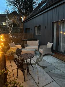 a patio with a table and chairs on a patio at Westwinds View in Ludlow