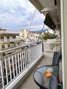 a balcony with a table and chairs on a balcony at Katerina's apartment in Serres