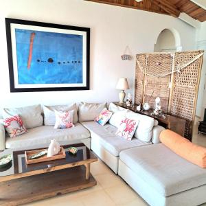 a living room with two couches and a table at BLUE HOUSE OCEAN VIEW in Santa Bárbara de Samaná