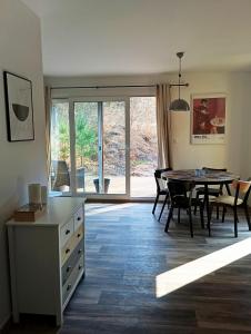 a kitchen and dining room with a table and chairs at DOMA Les in Včelná