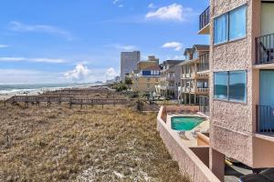 a view of the beach from the balcony of a building at Carolina Reef #705 in Myrtle Beach