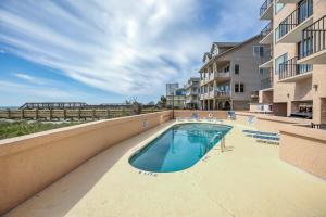 a swimming pool next to a apartment building at Carolina Reef #705 in Myrtle Beach