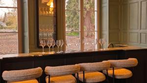 a bar with wine glasses on a counter at Château de l'Abbatiale in Braine