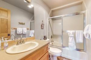 a bathroom with a sink and a toilet and a shower at Eagle Creek Chalet on the Pond in Redmond +14 photos