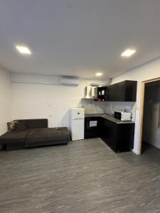 a living room with a couch and a kitchen at Beregi Apartman II in Mezőcsát +14 photos