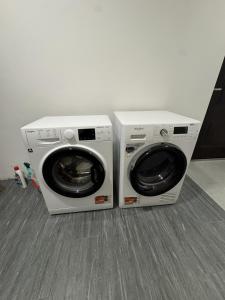 two washing machines are sitting next to each other at Beregi Apartman II in Mezőcsát
