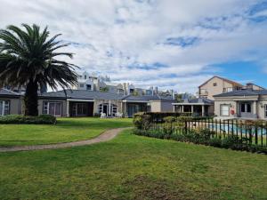 a house with a palm tree in the yard at Heaven at Sea in Mossel Bay