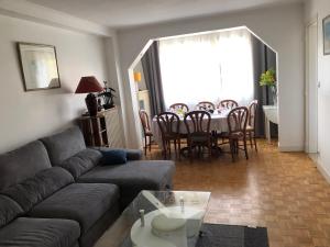 a living room with a couch and a table with chairs at Disneyland Paris in Chelles +14 photos
