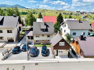 an aerial view of a small town with cars parked in a parking lot at Planinski vuk chalet in Žabljak
