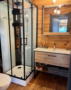 a bathroom with a glass shower and a sink at Paul Lake Escape Residence in Novosëlki +29 photos