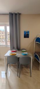 a table and two chairs in a room at Rafinù B&B in Ercolano