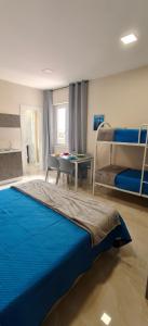 a bedroom with two bunk beds and a table at Rafinù B&B in Ercolano