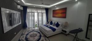 a bedroom with a white bed and a window at Easy stays baobab in Mombasa +121 photos