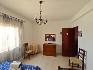 a living room with a chandelier and a bedroom at Pacheco's Guesthouse in Lagos