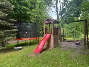 a playground with a slide and a gazebo at Chalupa Bišík in Teplice nad Metují