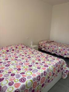 two beds sitting next to each other in a room at sweet rest in Castel Maggiore