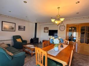 a living room with a table and a couch at Casa Rural María Josefa in Bronchales