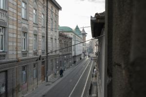 a person walking down a city street with buildings at Boutique Hotel Una in Sarajevo