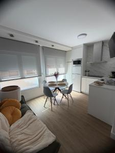 a kitchen and a living room with a table and chairs at Casa da Fonte in Rianjo