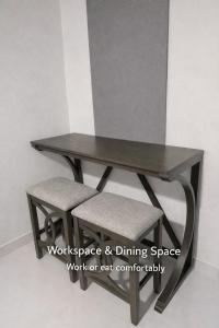 a wooden table and two chairs under a table at Modern Private Stay in Fajardo, PR - NEAR FERRY - BEACHES - EL YUNQUE - BIO BAY in Fajardo