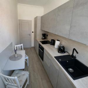 a kitchen with a sink and a counter top at Ferienwohnung Muranko in Bad Doberan +6 photos