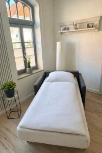 a large bed in a room with two windows at Ferienwohnung Muranko in Bad Doberan