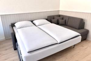 a bed with two pillows on it in a room at Ferienwohnung Muranko in Bad Doberan