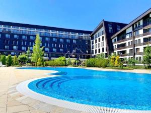 a large swimming pool in front of a building at Aspen Pirin View in Razlog