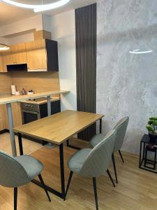 a kitchen with a wooden table and chairs at Aspen Pirin View in Razlog