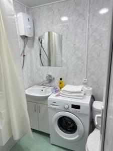 a bathroom with a washing machine and a sink at MN apartment in Yerevan in Yerevan