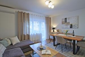 a living room with a couch and a dining room table at Luxury Apartment Ana in Otočac