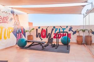 a room with a gym with a wall with graffiti at Wow Hotel Dakhla Gym, Free Jacuzzi & Breakfast Included in Dakhla