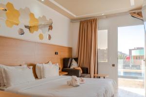 a hotel room with a bed and a chair at Wow Hotel Dakhla Gym, Free Jacuzzi & Breakfast Included in Dakhla +38 photos