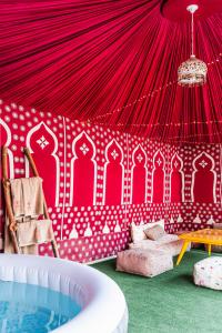 a room with a red tent with a tub at Wow Hotel Dakhla Gym, Free Jacuzzi & Breakfast Included in Dakhla