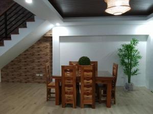 a dining room with a table and a potted plant at The Guest House Zambales in Cabangan