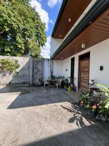 a patio of a house with a table and chairs at The Guest House Zambales in Cabangan +17 photos