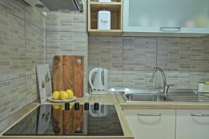 a kitchen with a sink and a plate of fruit at Luxury Apartment Ana in Otočac +35 photos