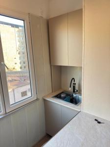 a small kitchen with a sink and a window at MN apartment in Yerevan in Yerevan