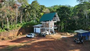 a house with two trucks parked in front of it at Misty Nature Resort in Ratnapura
