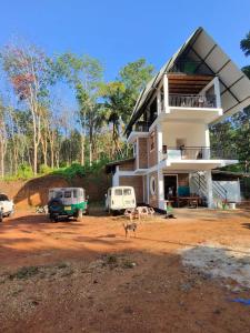 a house with vehicles parked in front of it at Misty Nature Resort in Ratnapura +35 photos