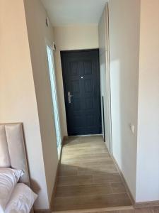 a hallway with a black door in a room at MN apartment in Yerevan in Yerevan