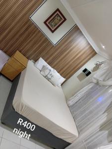 a hotel room with a bed in a room at 3 bedroom self catering in Rustenburg