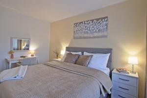 a bedroom with a large bed and a desk at Luxury Apartment Ana in Otočac