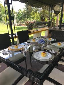a glass table with plates of food on it at Balsora Hotel Boutique in La Tebaida