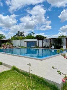 a swimming pool in a building with a blue sky at Chácara Jacinto Alves in Paulo Afonso