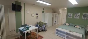 a room with a bed and a table and a chair at Volta B&B Imola in Imola