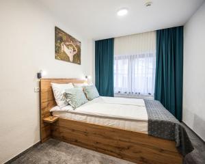 a bedroom with a large bed with a window at Boutique Hotel Una in Sarajevo