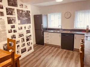 a kitchen with a black refrigerator and a sink at The Old Printworks, Kirkwall in Orkney